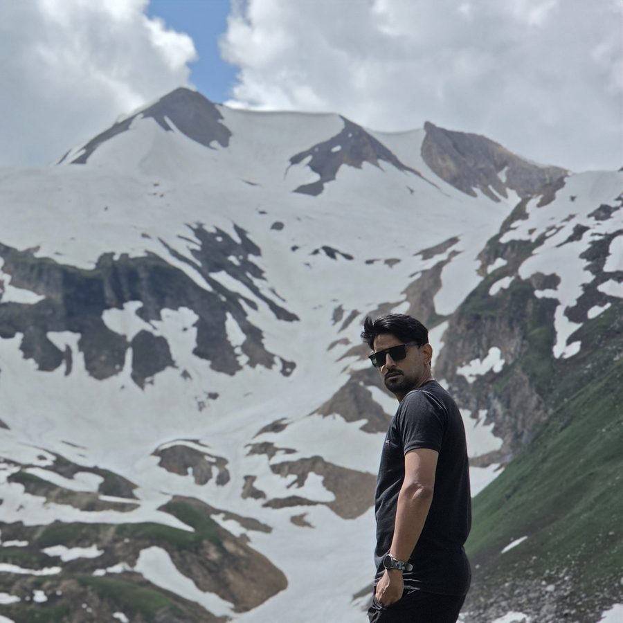 Furqan below a snow-capped peak in the north